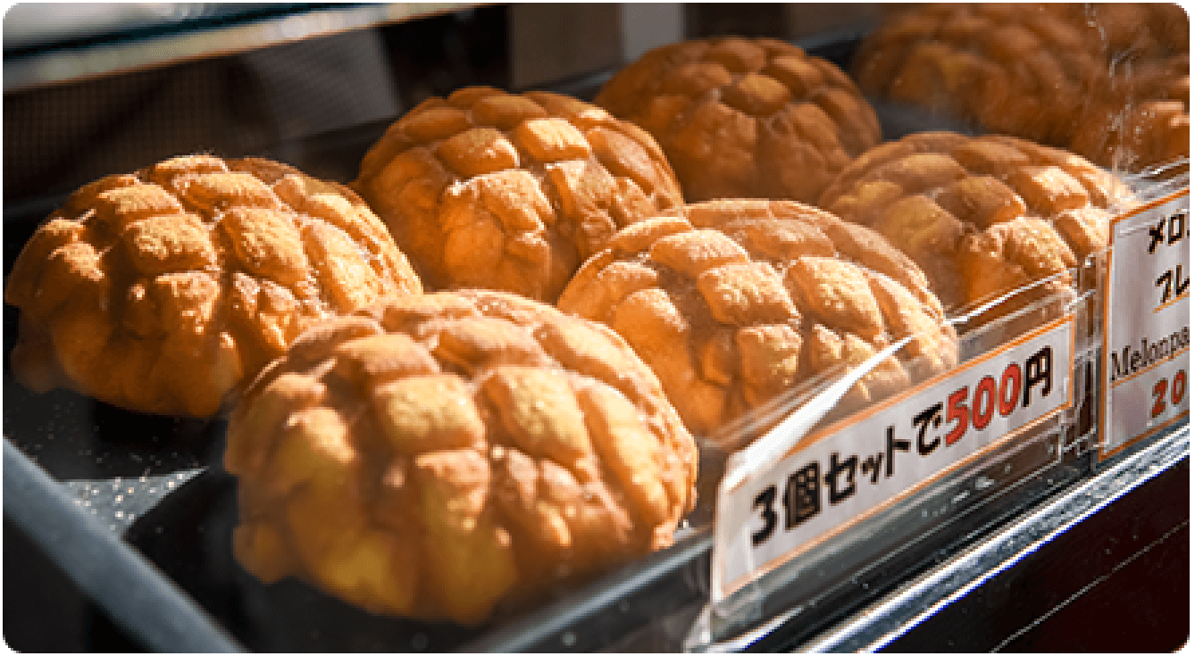 Several melonpan breads with crosshatch patterns, illustrating popular Japanese baked goods.